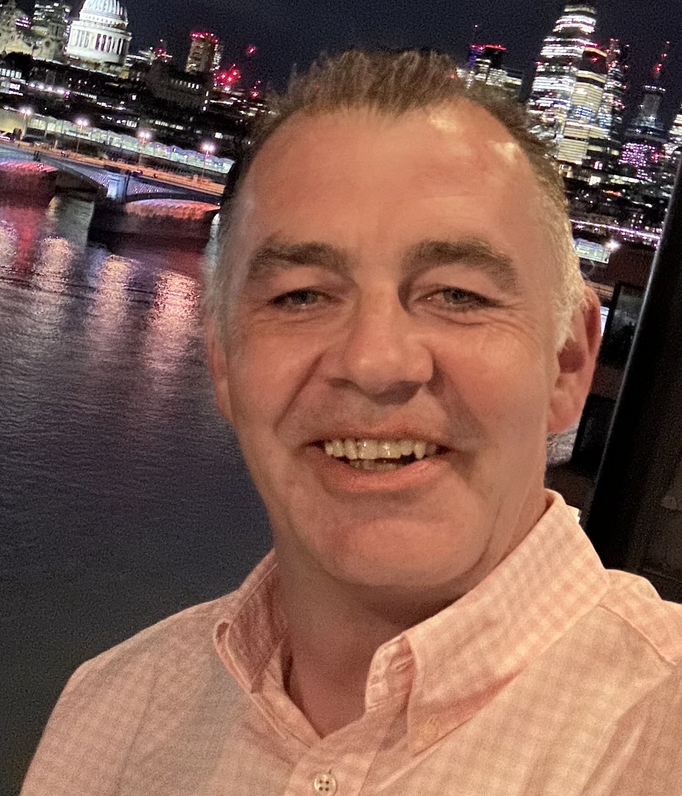Stephen Fielding, smiling, photographed outdoors in London at night